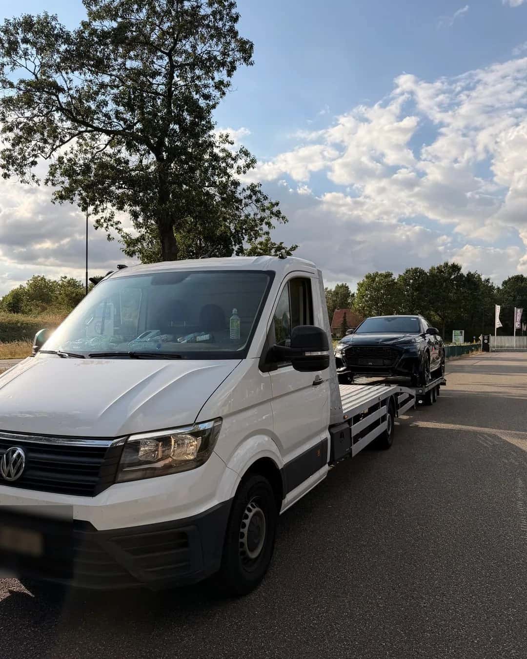 Witte oprijwagen met een geladen beschadigde SUV
